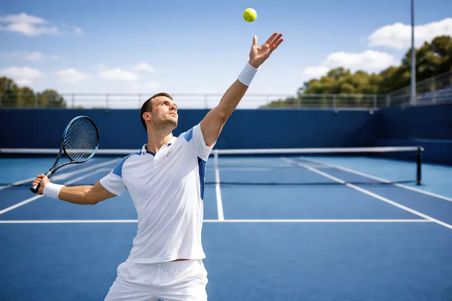 Tenista en el momento exacto de lanzar la pelota para servir
